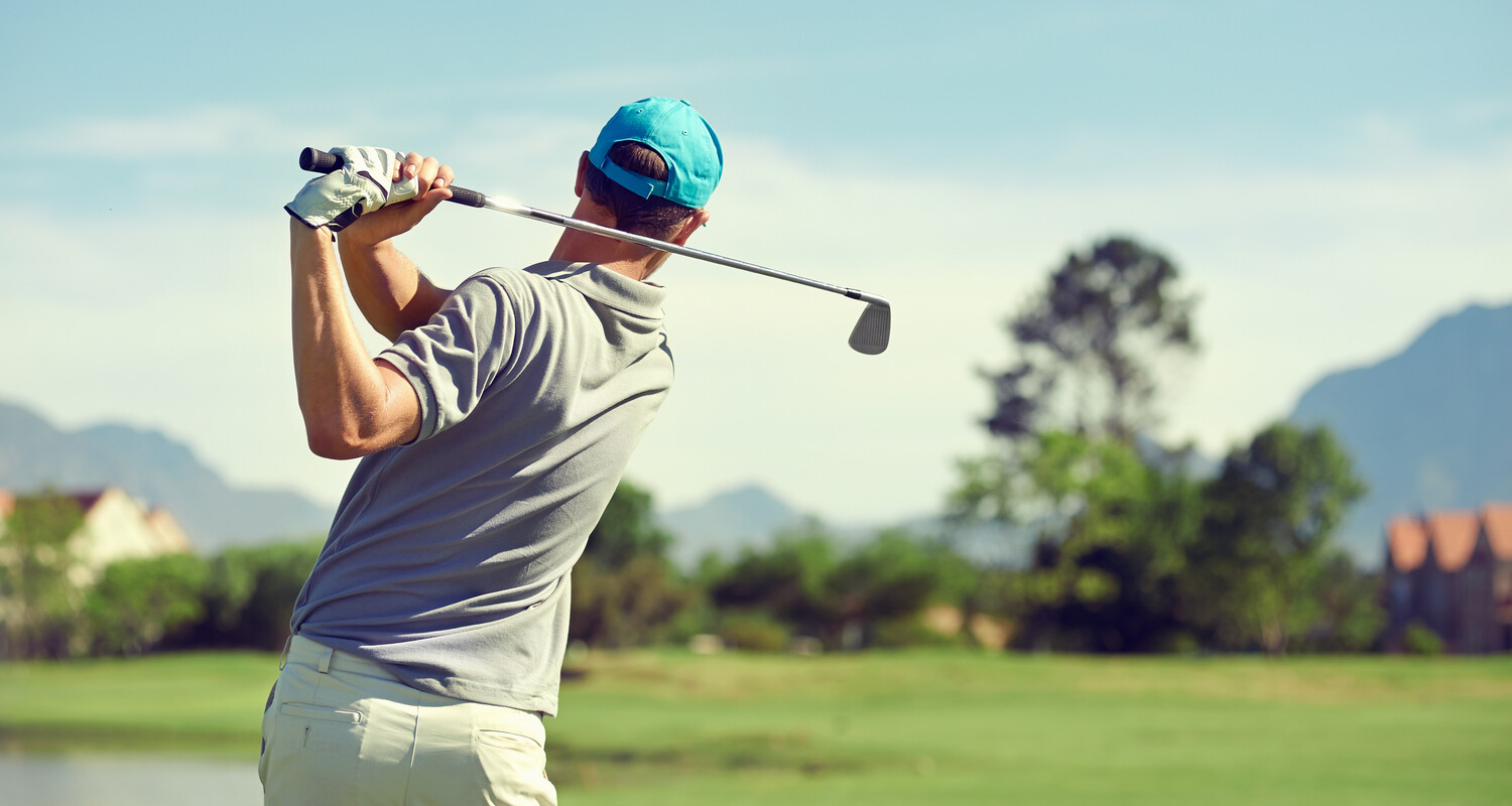 a man swinging a golf club