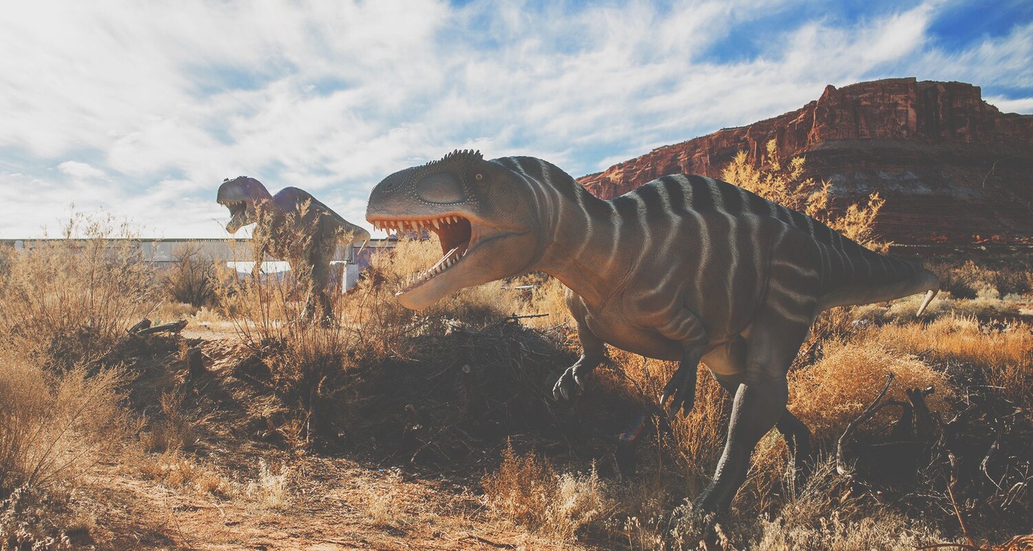 a dinosaur in a field