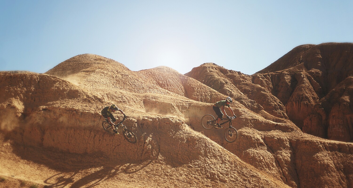 a group of people riding bikes on a hill